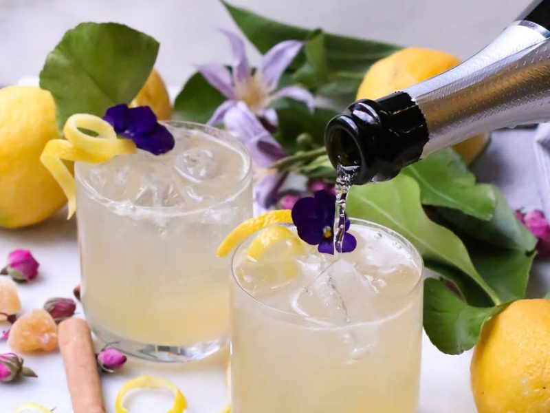 champagne pouring into glasses of cocktails