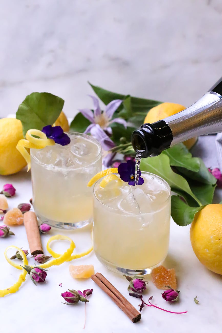 champagne pouring into glasses of cocktails