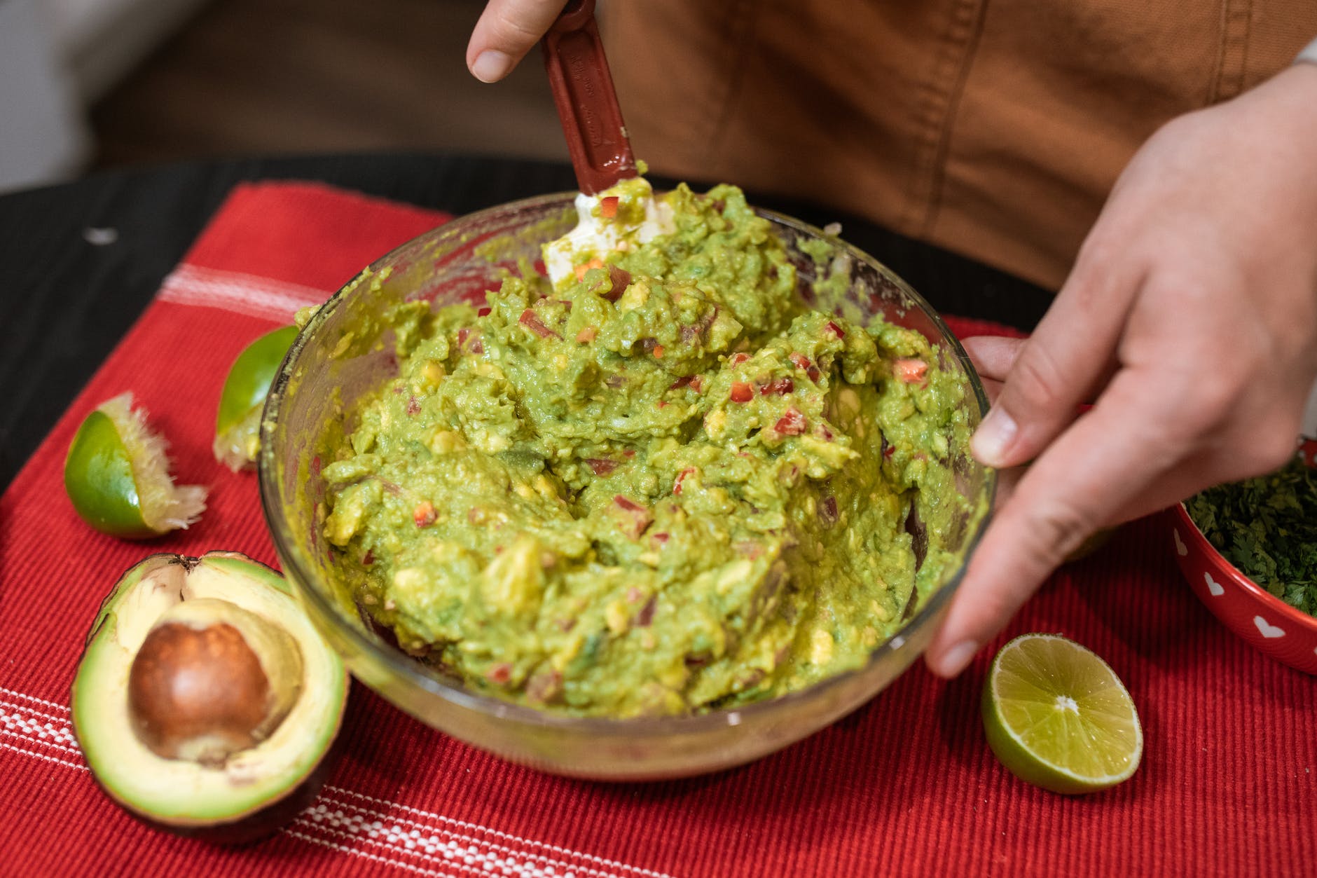 person making guacamole